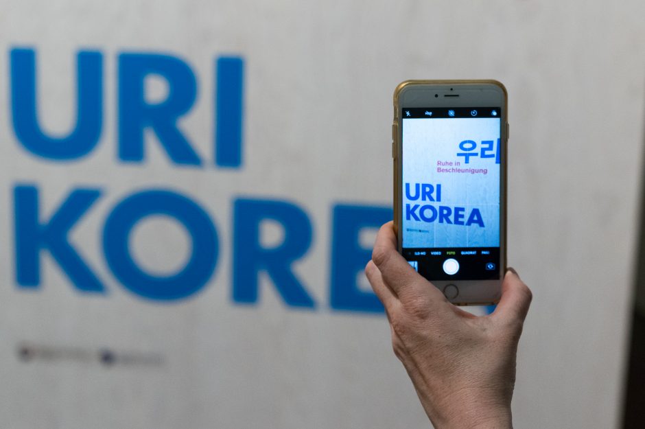 View of the exhibition, smartphone takes a photo of the lettering Uri Korea