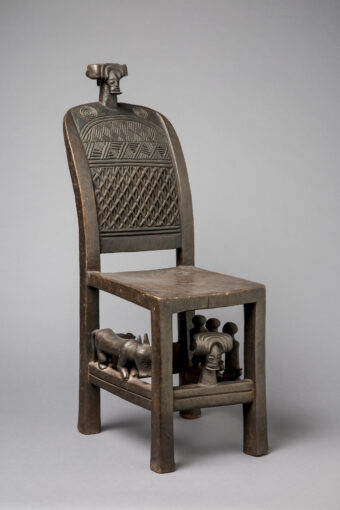 wooden chair with symbolic carvings