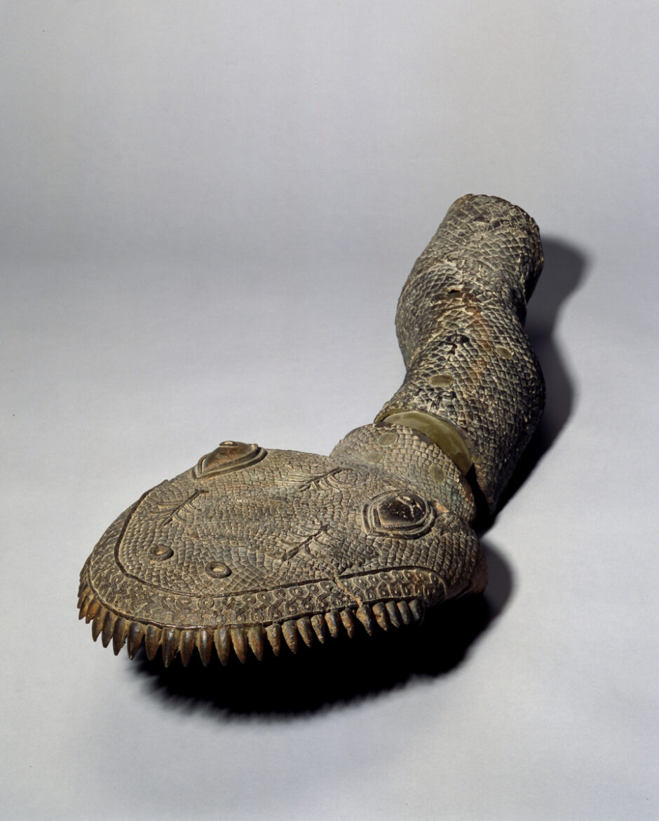 Sculpture of a snake's head with fragment of a snake's body