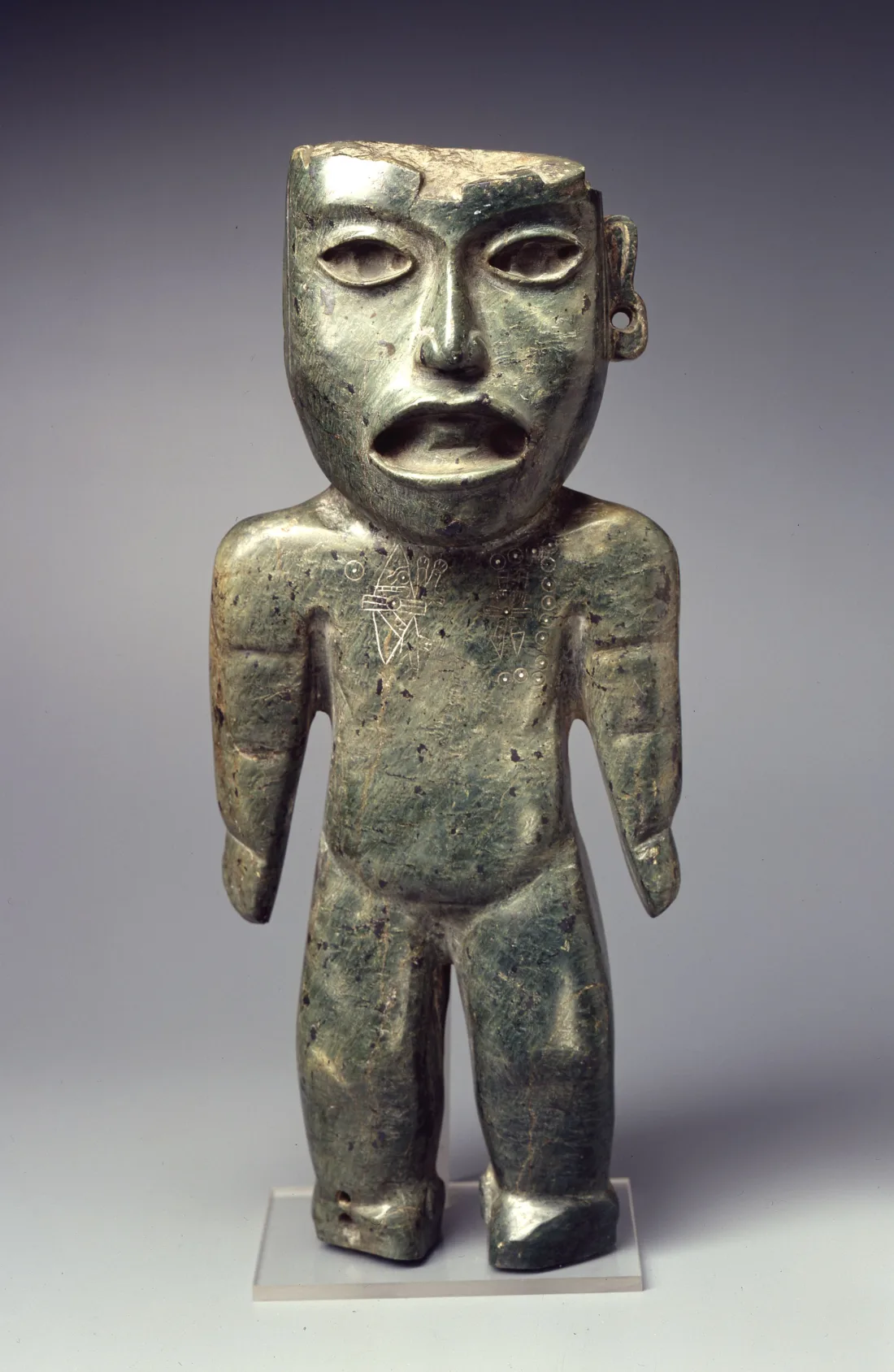 Stone figure with incised glyphs