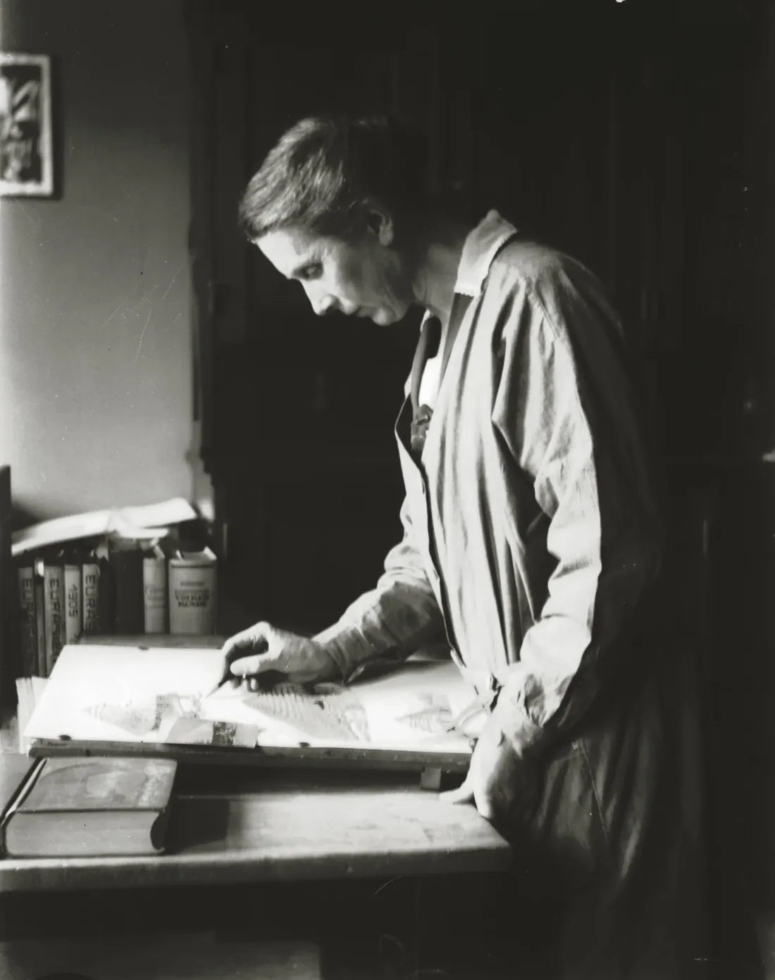 Woman drawing, room, work desk, books, b/w photograph