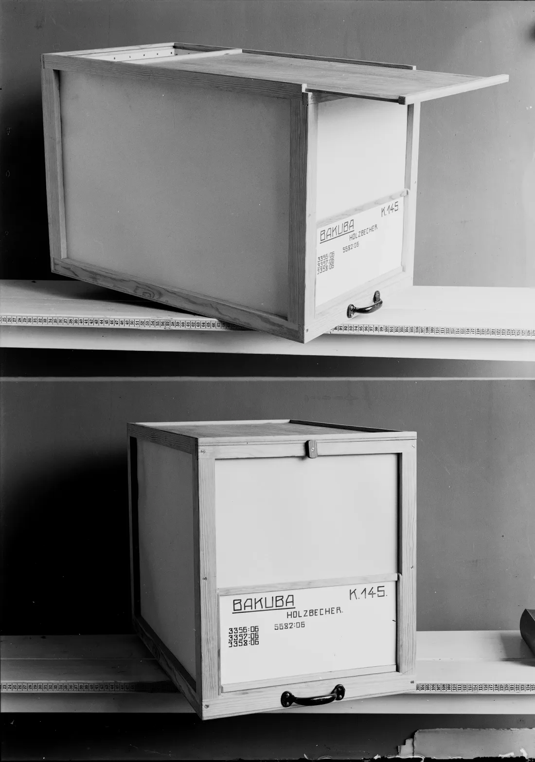 Two shelf boards, two labelled wooden boxes, b/w photograph