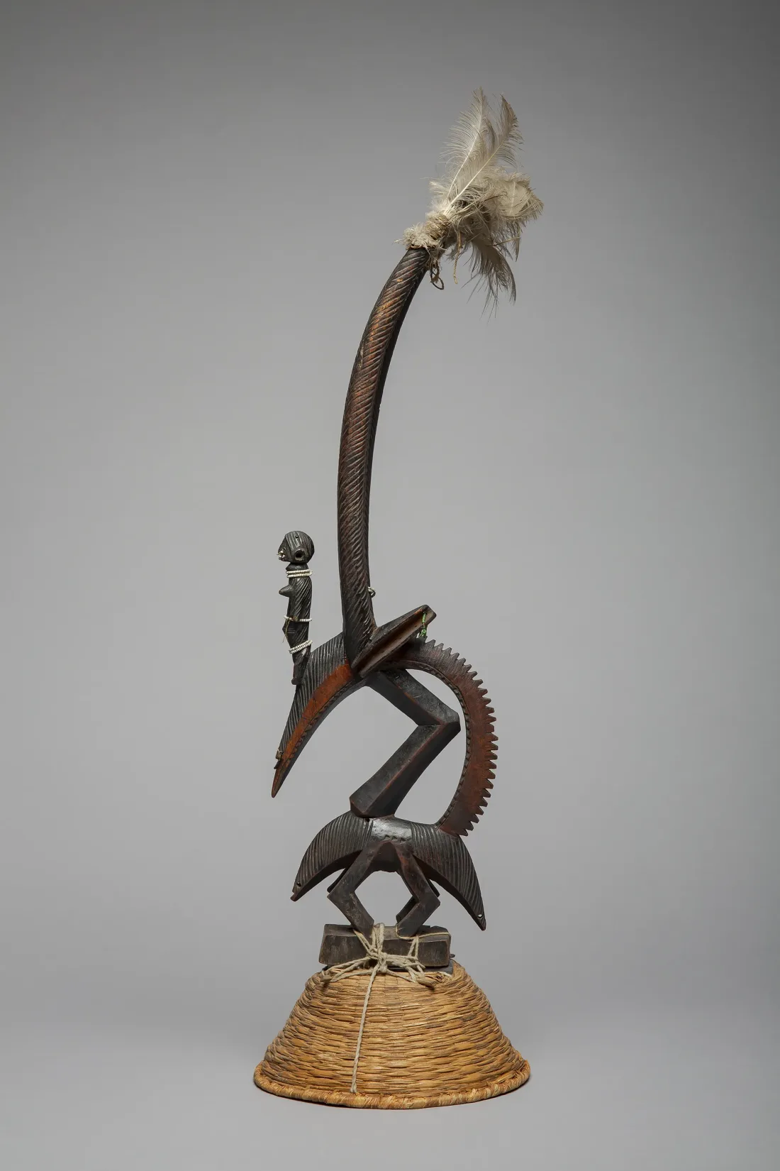 Standing figure, wood, plant fiber braid, feathers, before 1908
